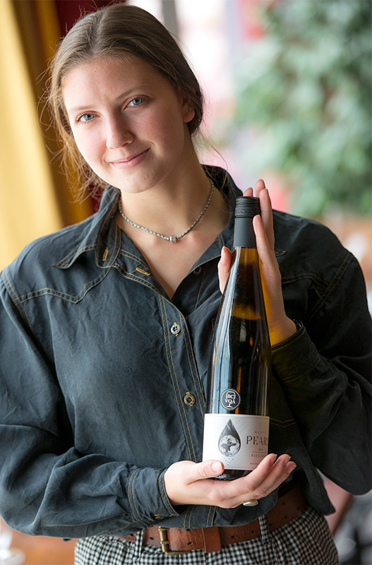 Girl presenting a CSW wine bottle